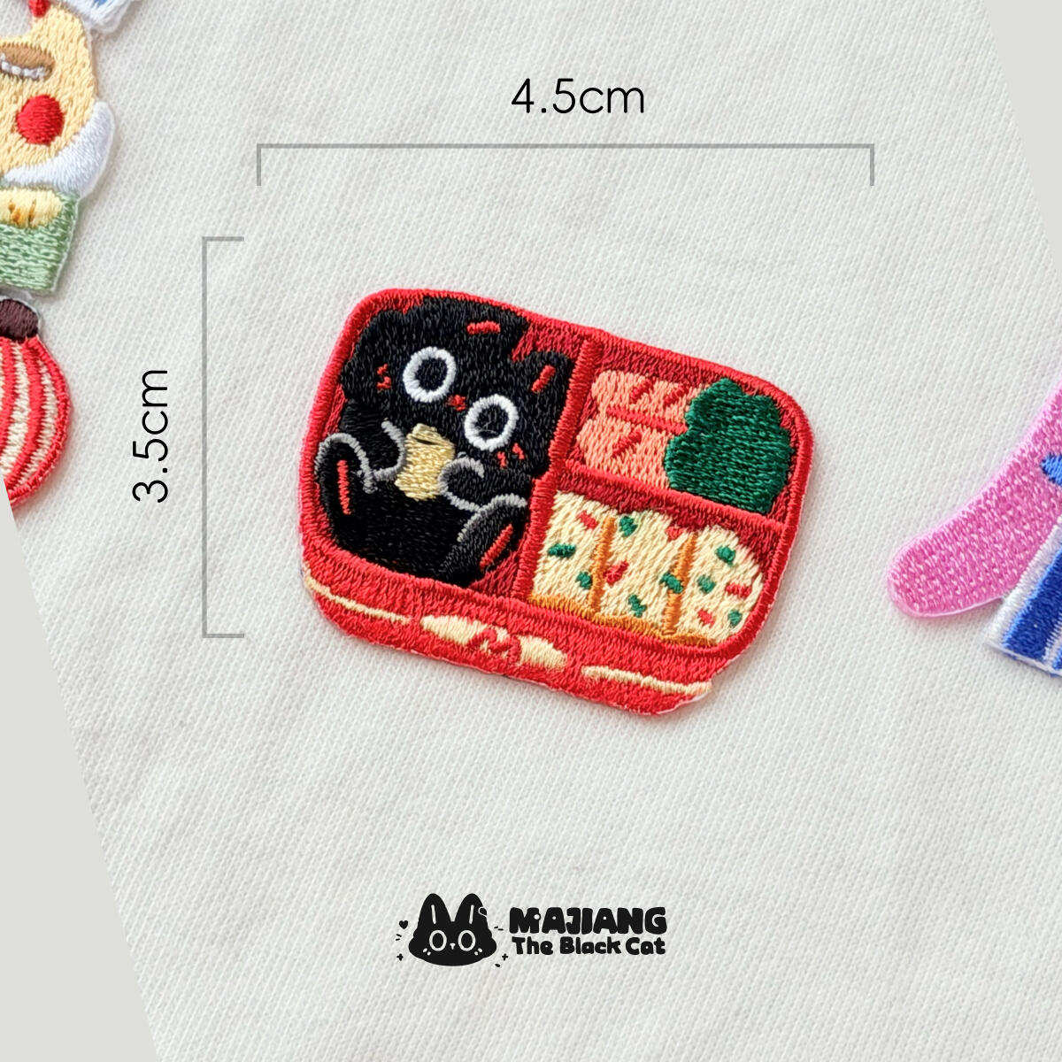 Bento Box patch: Majiang curled up in a red bento box, 45 × 35 mm