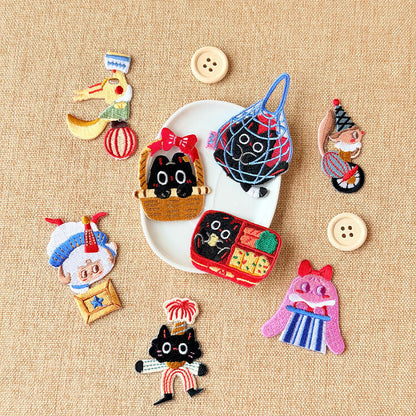 Majiang the Black Cat embroidered patches: the full series of eight around a white plate with buttons