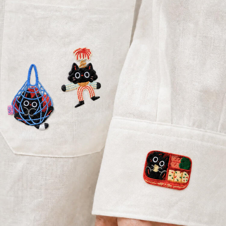 Majiang patches ironed onto the pocket and cuff of a white shirt