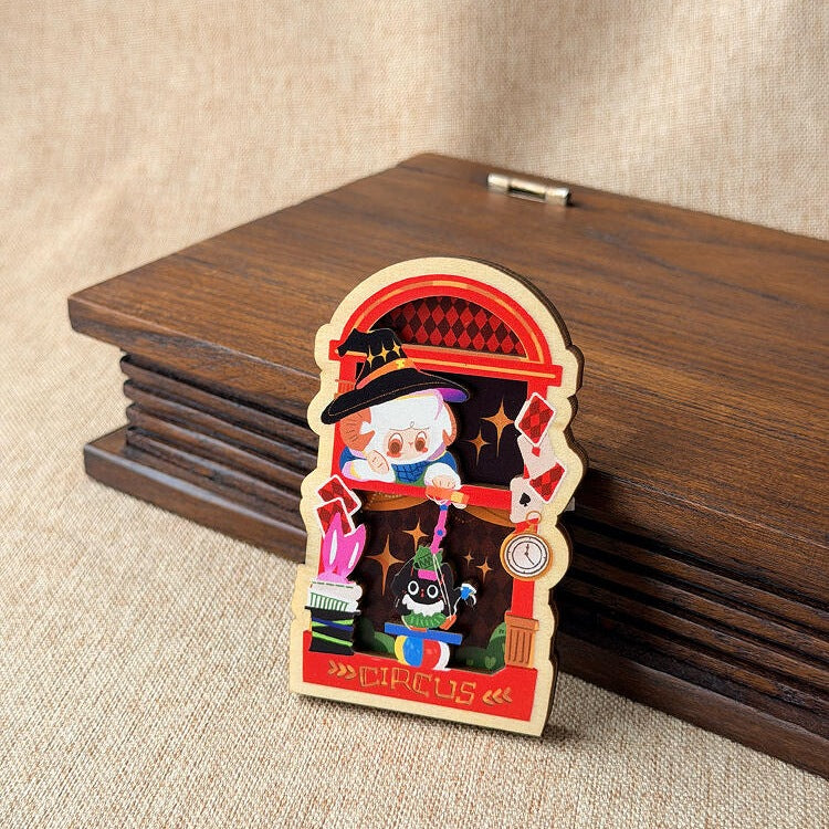 Red A-Mie magnet propped against a wooden box